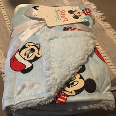 a mickey mouse blanket with a tag on it