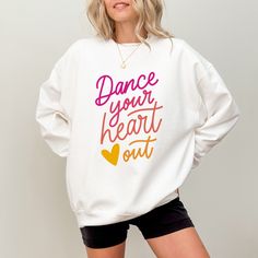 This cute Dance Your Heart Out sweatshirt is also available in a Comfort Colors® T shirt style. Visit our shop to see them and more dance sweatshirts & Dance shirts! ▸ Gildan Brand Sweatshirt in WHITE   ▸ Unisex Adult Sizing   ▸ 50% Cotton, 50% Polyester ▸ Medium-Heavy Fabric ▸ Rolled Sleeves in pictures is for styling purposes only   ▸ Props used In photos are NOT included with purchase SIZE ▸ Take a look at the photos to see a specific sizing chart for this sweatshirt style ▸ Please note that these sweatshirts are unisex size meaning they are not women's fitted sweatshirts ▸ Lay your favorite sweatshirt at home flat and measure armpit to armpit to compare to the size chart in the photos Dance Studio Merchandise, Dance Shirts Ideas Dancers, White Casual Dance Top, White Casual Tops For Dance, Casual White Top For Dance, Crew Neck Sweatshirt With Letter Print For Dance, Graphic Print Crew Neck Sweatshirt For Dance, Crew Neck Graphic Print Sweatshirt For Dance, Casual Letter Print Sweatshirt For Dance