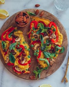 an omelet with vegetables and nuts on a wooden plate