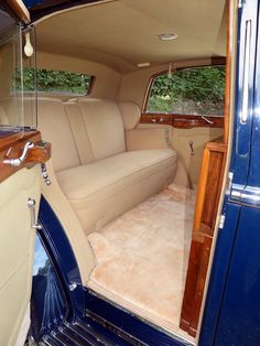 the interior of an old car with wood trim