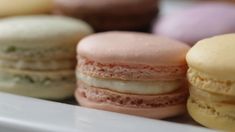 there are many different colored macaroons on the plate