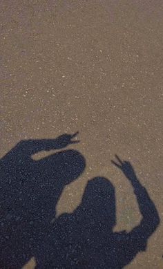 the shadow of a person holding a frisbee