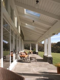 an outdoor covered patio with chairs and tables