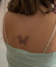 a woman with a butterfly tattoo on her back