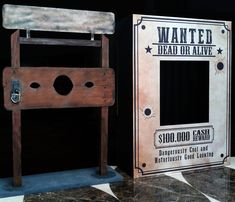 an old fashioned wooden dead or alive sign next to a cardboard box on the floor