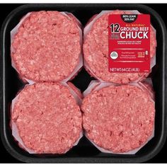 four hamburger patties in a black tray on a white background with the label'all natural ground chuck '