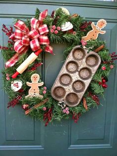 a christmas wreath with cupcakes and decorations on it