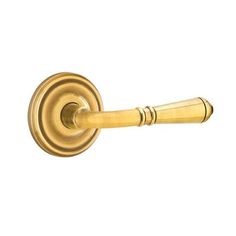 an antique brass door handle on a white background