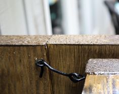 a close up of a wooden fence with a chain attached to the top of it