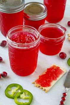 cranberry sauce in mason jars with pickles and crackers on the side