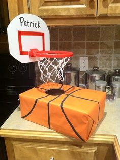 an orange box with a basketball on it is in the middle of a kitchen counter