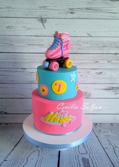 a three tiered cake with roller skates on top