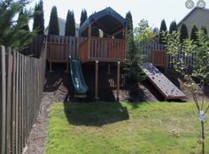 a backyard with a play set and slide