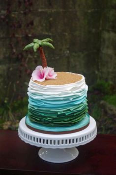 a multi layer cake with a flower on top