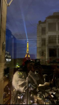 the eiffel tower seen through a window at night