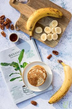 a banana and cinnamon smoothie on a plate next to some pecans, walnuts and bananas