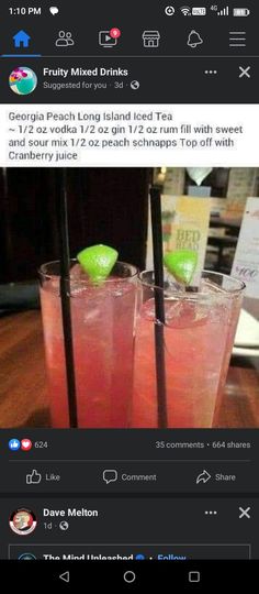 two glasses filled with drinks sitting on top of a wooden table