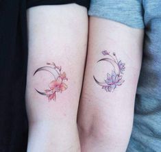 two women with matching tattoos on their arms, one has a crescent and the other has flowers