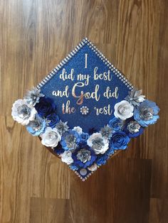 a blue graduation cap decorated with flowers and the words, i did my best and god did the rest