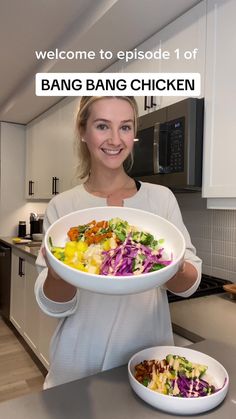 a woman holding a large plate of food in front of her face with the words bang bang chicken on it