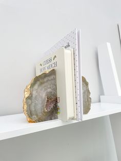 there is a book that is on the shelf with it's cover pulled open