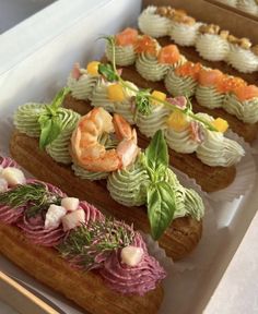 there are many different types of sushi on the tray in this case, including shrimp and praw