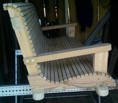 a wooden chair sitting on top of a hard wood floor next to a metal rail