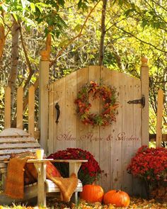 an autumn day blessing sign surrounded by fall foliage and pumpkins in the foreground