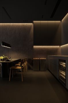 a dimly lit kitchen with an oven and dining table in the center, surrounded by chairs