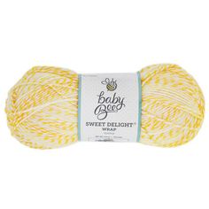 the yarn ball is yellow and white, with a baby bee on it's side