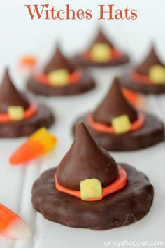 chocolate candy witches hats on top of each other with orange and yellow candies in the middle