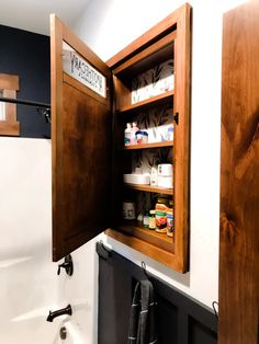 an open medicine cabinet in a bathroom next to a sink