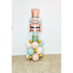 a nutcracker standing on top of balloons in the shape of a ballon