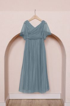 a blue dress hanging on a wooden hanger