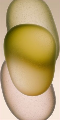 three white and yellow vases sitting on top of each other