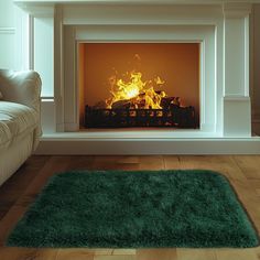 a living room with a fire place in the center and green rug on the floor