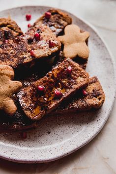 a white plate topped with french toast and cut in half gingerbreads on top of each other