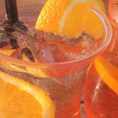 orange slices and ice in a glass with water