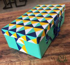 a colorful box sitting on top of a wooden table