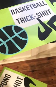 the basketball trick - shot sign is hanging from the ceiling in front of other signs