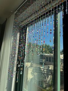 a window with beads hanging from it's side