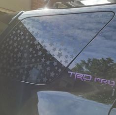 a car with stars painted on it parked in front of a building and the word, trd pro