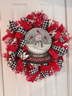 a christmas wreath with a snowman on it