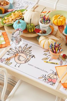 a table topped with paper turkeys and other thanksgiving crafts for kids to draw on