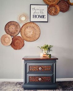 a dresser with baskets on the wall above it