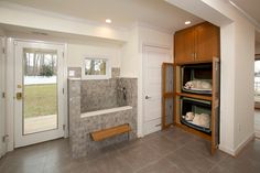 an empty bathroom with two shelves on the wall