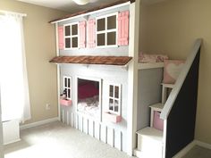 a child's bedroom with a doll house and stairs to the second floor area