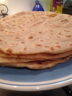 three flat breads on a blue plate