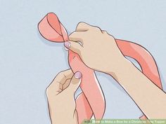 someone is tying a pink ribbon around their wrist and thumbnails to tie it together