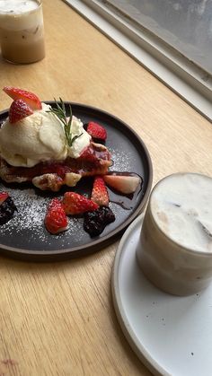 a plate topped with fruit covered in ice cream next to a cup of cappuccino